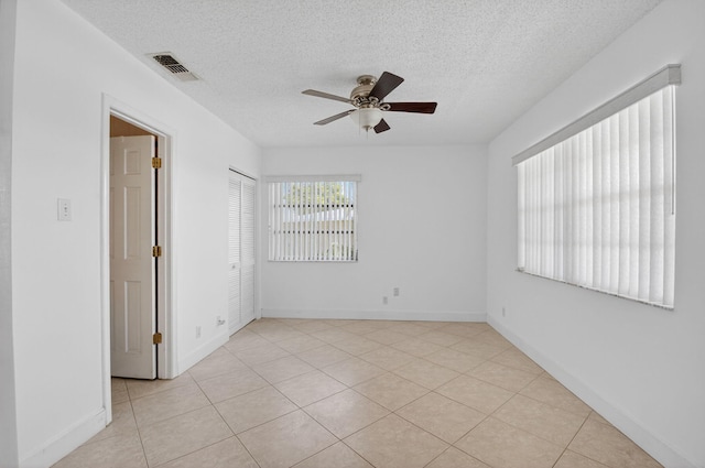 1111 Lemon Tree Ter Unit 204, Delray Beach, FL 33445 - spare room featuring ceiling fan, a textured ceiling, and light tile patterned flooring