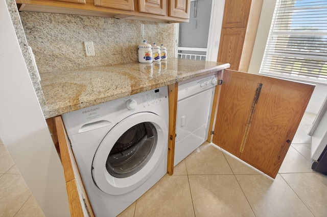 1111 Lemon Tree Ter Unit 204, Delray Beach, FL 33445 - washroom featuring washer / dryer and light tile patterned floors