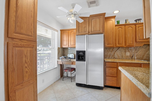 1111 Lemon Tree Ter Unit 204, Delray Beach, FL 33445 - kitchen with stainless steel fridge, light tile patterned flooring, decorative backsplash, light stone counters, and ceiling fan
