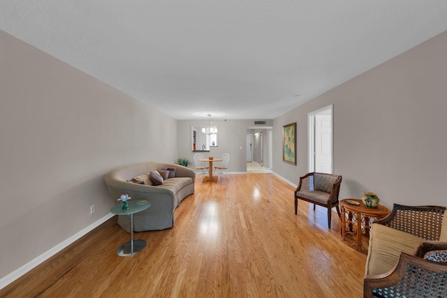 14623 Bonaire Blvd Unit 203, Delray Beach, FL 33446 - living area with light wood-type flooring and a chandelier