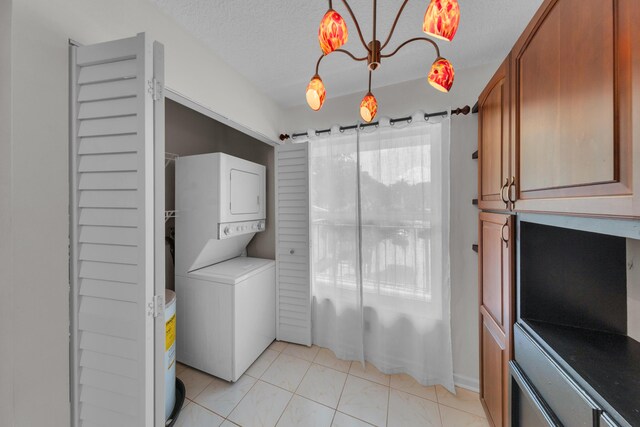 14623 Bonaire Blvd Unit 203, Delray Beach, FL 33446 - laundry room featuring stacked washing machine and dryer and a textured ceiling