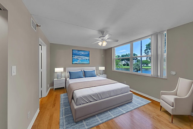 14623 Bonaire Blvd Unit 203, Delray Beach, FL 33446 - bedroom featuring a water view, light wood-style flooring, and a ceiling fan