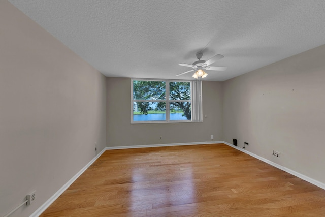 14623 Bonaire Blvd Unit 203, Delray Beach, FL 33446 - unfurnished room with light wood-style flooring, a textured ceiling, and ceiling fan