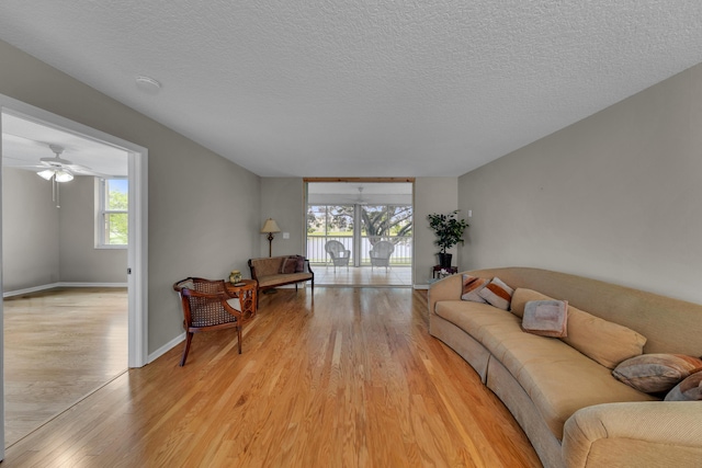 14623 Bonaire Blvd Unit 203, Delray Beach, FL 33446 - living room featuring light wood finished floors, a textured ceiling, and ceiling fan