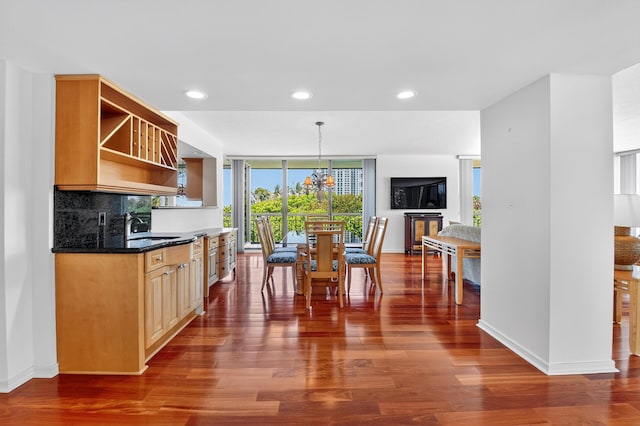 4000 N Ocean Dr Unit 204, Singer Island, FL 33404 - kitchen with dark wood-type flooring, open shelves, backsplash, a wall of windows, and a chandelier
