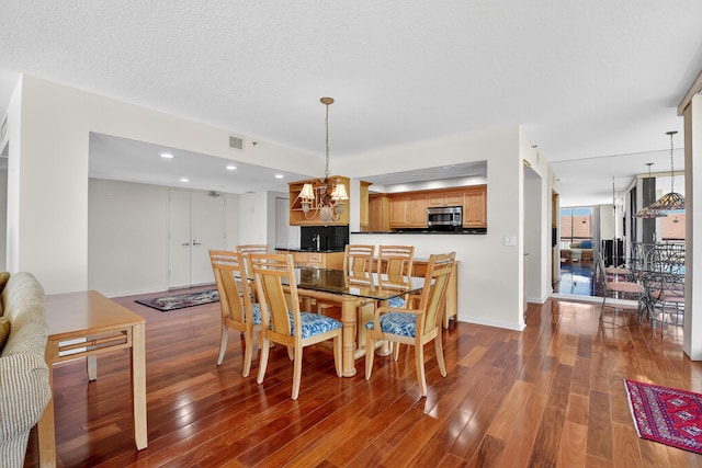 4000 N Ocean Dr Unit 204, Singer Island, FL 33404 - dining area featuring wood finished floors, a chandelier, and recessed lighting