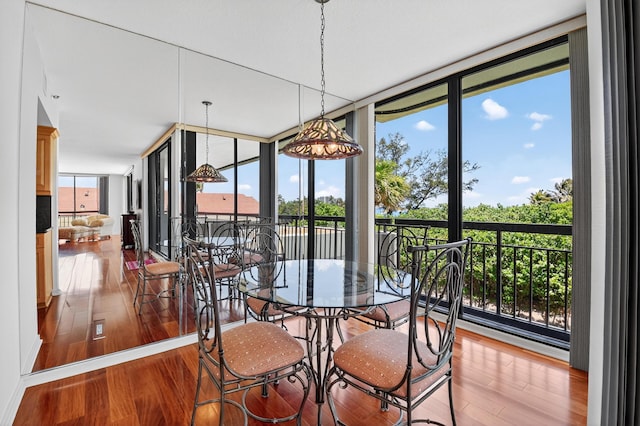 4000 N Ocean Dr Unit 204, Singer Island, FL 33404 - dining room with wood finished floors, expansive windows, and plenty of natural light