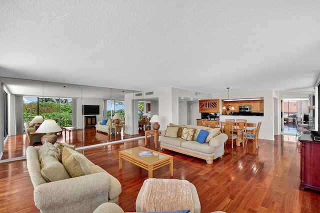 4000 N Ocean Dr Unit 204, Singer Island, FL 33404 - living room featuring a textured ceiling and wood finished floors