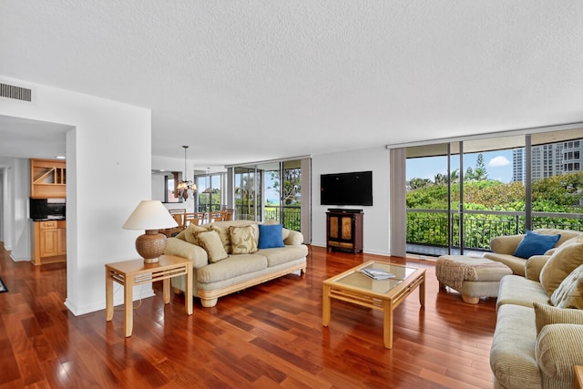 4000 N Ocean Dr Unit 204, Singer Island, FL 33404 - living room with a textured ceiling, dark wood-style flooring, and a wall of windows
