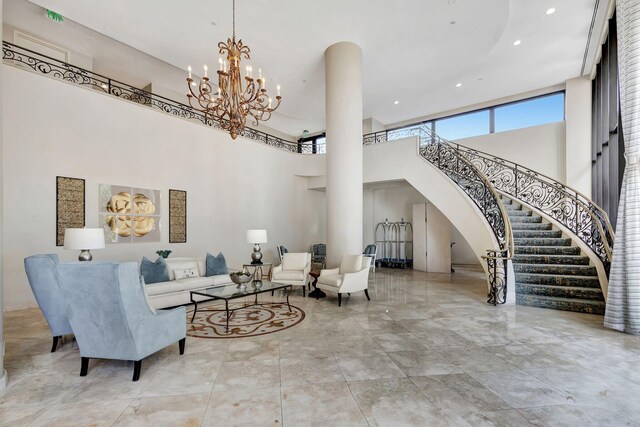 4000 N Ocean Dr Unit 204, Singer Island, FL 33404 - living room featuring a towering ceiling, arched walkways, a chandelier, stairs, and recessed lighting