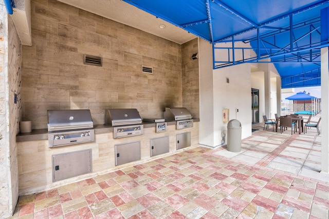 4000 N Ocean Dr Unit 204, Singer Island, FL 33404 - view of patio with outdoor dining space and exterior kitchen