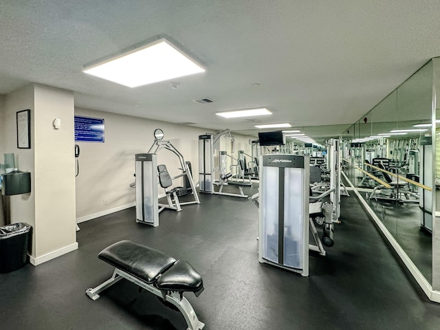 4000 N Ocean Dr Unit 204, Singer Island, FL 33404 - workout area with baseboards and a textured ceiling