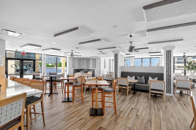 4000 N Ocean Dr Unit 204, Singer Island, FL 33404 - dining area with a ceiling fan, light wood finished floors, and floor to ceiling windows