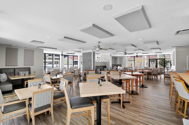 4000 N Ocean Dr Unit 204, Singer Island, FL 33404 - dining room featuring healthy amount of natural light, a ceiling fan, expansive windows, and light wood-type flooring