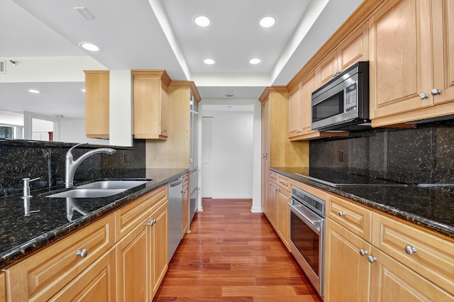 4000 N Ocean Dr Unit 204, Singer Island, FL 33404 - kitchen with stainless steel appliances, light wood-type flooring, recessed lighting, dark stone countertops, and decorative backsplash