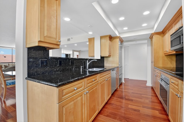 4000 N Ocean Dr Unit 204, Singer Island, FL 33404 - kitchen featuring stainless steel appliances, light wood-type flooring, light brown cabinets, and recessed lighting