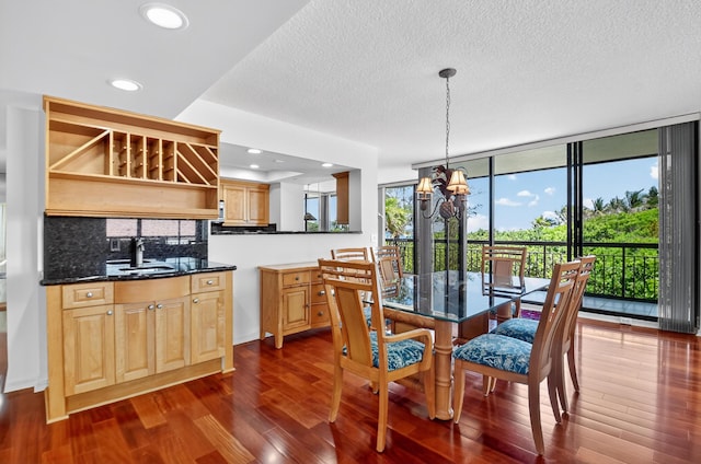 4000 N Ocean Dr Unit 204, Singer Island, FL 33404 - dining area featuring a chandelier, dark wood-style flooring, a textured ceiling, and recessed lighting