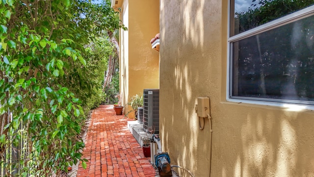 12471 SW 1st St, Plantation, FL 33325 - view of side of property featuring stucco siding and a central AC unit