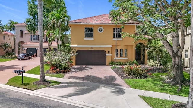 12471 SW 1st St, Plantation, FL 33325 - mediterranean / spanish-style home featuring decorative driveway, stucco siding, a garage, and a tiled roof