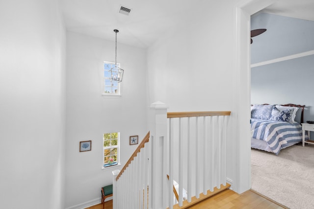 326 Tuxedo Ln, West Palm Beach, FL 33401 - staircase with a chandelier and wood finished floors