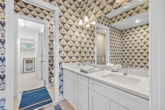 326 Tuxedo Ln, West Palm Beach, FL 33401 - bathroom with wallpapered walls and double vanity