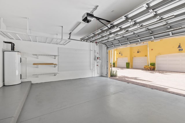 326 Tuxedo Ln, West Palm Beach, FL 33401 - garage featuring water heater and a garage door opener