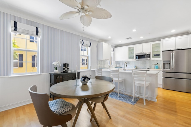326 Tuxedo Ln, West Palm Beach, FL 33401 - dining space featuring crown molding, a ceiling fan, light wood-type flooring, and recessed lighting