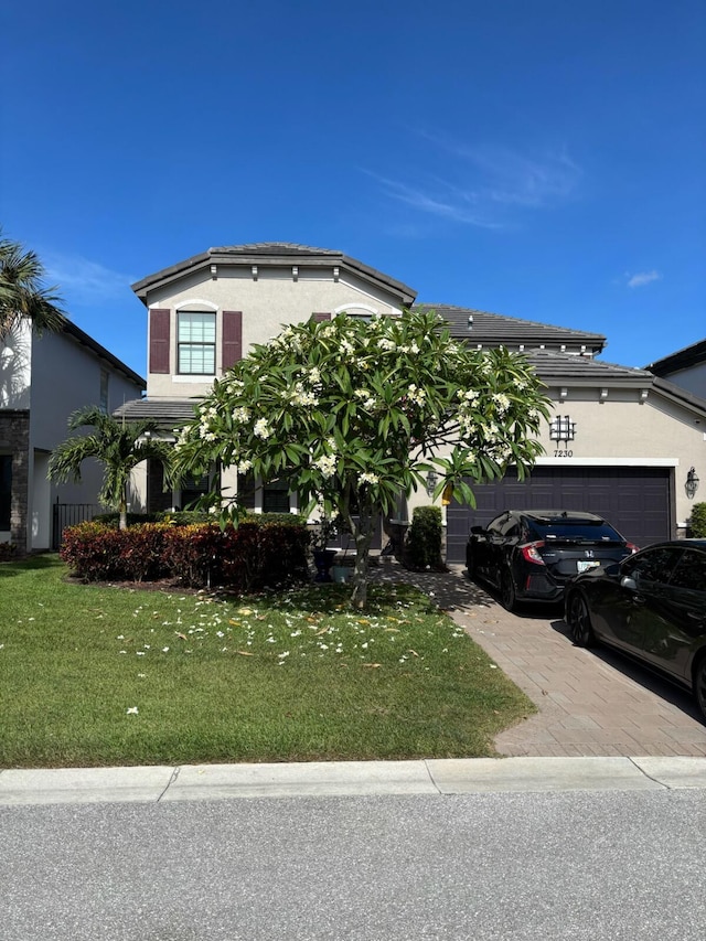 7230 Sandgrace Ln, Lake Worth, FL 33463 - view of front of property with stucco siding, an attached garage, a front lawn, and driveway