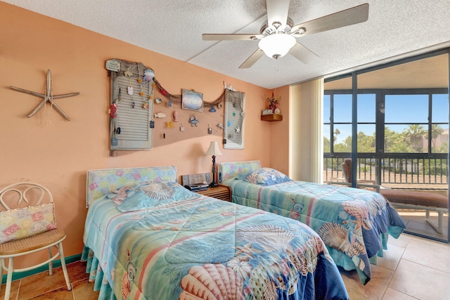 2400 S Ocean Dr Unit 4223, Fort Pierce, FL 34949 - bedroom featuring access to exterior, a textured ceiling, tile patterned floors, and a ceiling fan