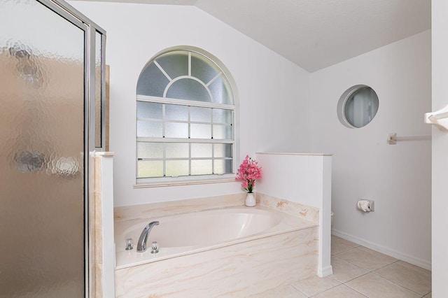2062 SW Scorpio Ln, Port Saint Lucie, FL 34984 - bathroom with a shower stall, a garden tub, tile patterned flooring, and lofted ceiling
