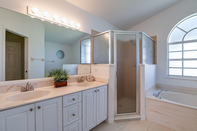 2062 SW Scorpio Ln, Port Saint Lucie, FL 34984 - bathroom with a shower stall, double vanity, a garden tub, tile patterned flooring, and vaulted ceiling