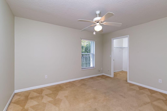 2062 SW Scorpio Ln, Port Saint Lucie, FL 34984 - empty room featuring light carpet, a ceiling fan, and a textured ceiling