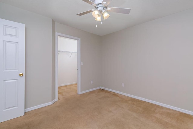 2062 SW Scorpio Ln, Port Saint Lucie, FL 34984 - unfurnished bedroom with light carpet, a spacious closet, a closet, and ceiling fan