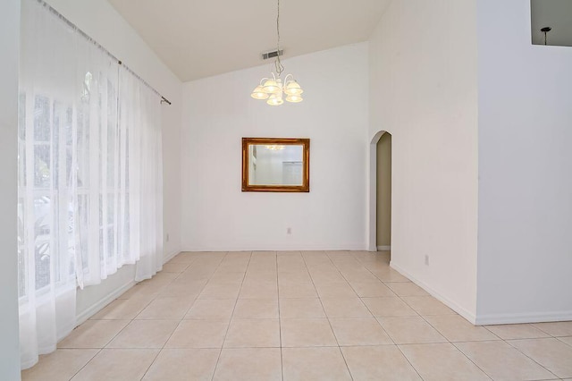2062 SW Scorpio Ln, Port Saint Lucie, FL 34984 - unfurnished dining area featuring arched walkways, a chandelier, high vaulted ceiling, and light tile patterned flooring