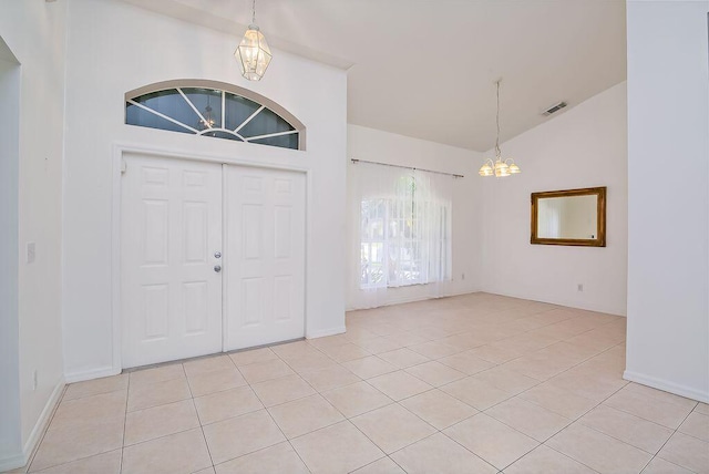 2062 SW Scorpio Ln, Port Saint Lucie, FL 34984 - entryway featuring a chandelier, light tile patterned floors, and high vaulted ceiling
