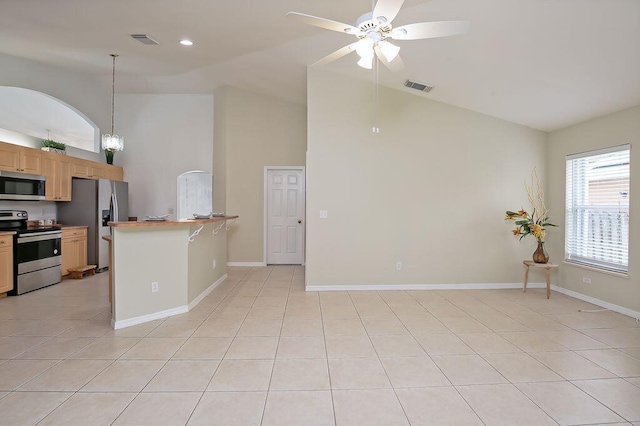 2062 SW Scorpio Ln, Port Saint Lucie, FL 34984 - kitchen with stainless steel appliances, high vaulted ceiling, ceiling fan, light tile patterned floors, and decorative light fixtures