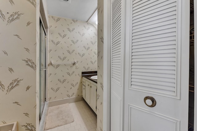 1261 NW 44th St, Deerfield Beach, FL 33064 - full bath featuring a closet, wallpapered walls, vanity, a stall shower, and tile patterned floors