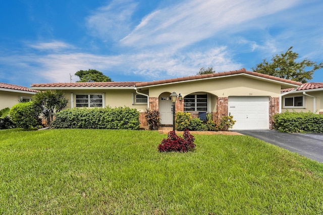 1261 NW 44th St, Deerfield Beach, FL 33064 - view of front of property with an attached garage, asphalt driveway, a tile roof, a front lawn, and stucco siding