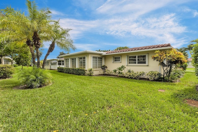 1261 NW 44th St, Deerfield Beach, FL 33064 - view of front of property with stucco siding, a front lawn, and a tile roof