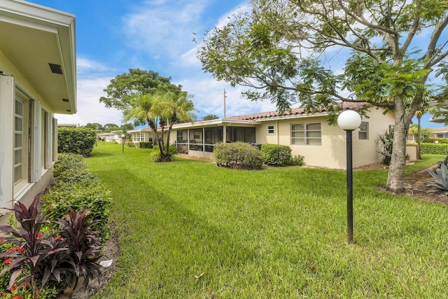1261 NW 44th St, Deerfield Beach, FL 33064 - view of grassy yard with a sunroom