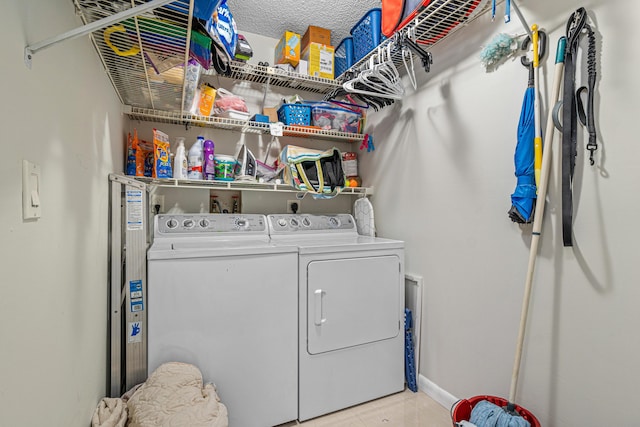 241 Meadows Dr Unit 241, Boynton Beach, FL 33436 - laundry room with washing machine and dryer, light tile patterned floors, and a textured ceiling