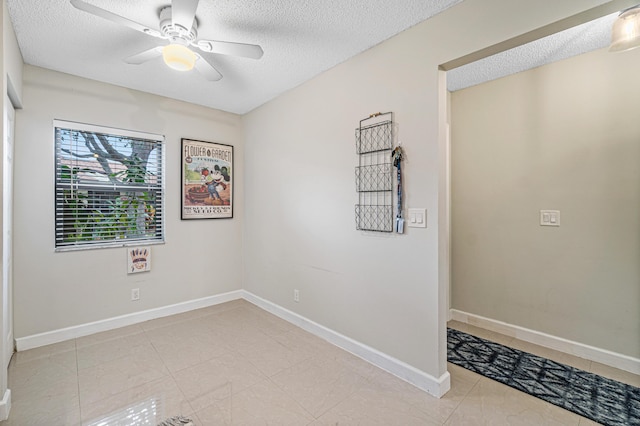241 Meadows Dr Unit 241, Boynton Beach, FL 33436 - spare room with ceiling fan, a textured ceiling, and light tile patterned floors