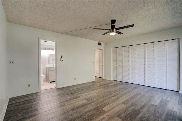 4110 Newport U Unit 4110, Deerfield Beach, FL 33442 - unfurnished bedroom with wood finished floors, a textured ceiling, ensuite bathroom, and ceiling fan