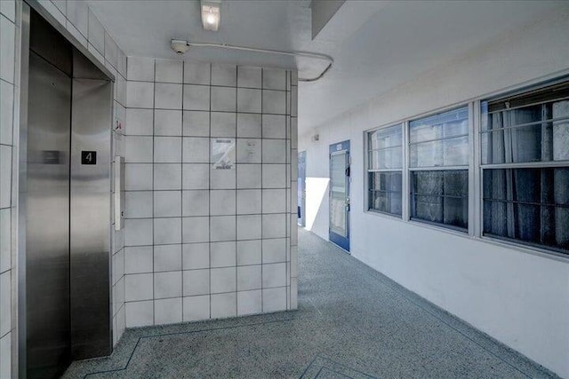 4110 Newport U Unit 4110, Deerfield Beach, FL 33442 - hallway featuring elevator and speckle patterned floor
