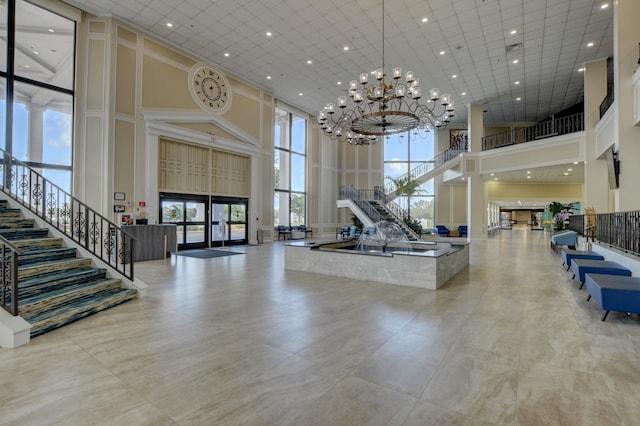 4110 Newport U Unit 4110, Deerfield Beach, FL 33442 - building lobby featuring a towering ceiling, stairway, and recessed lighting