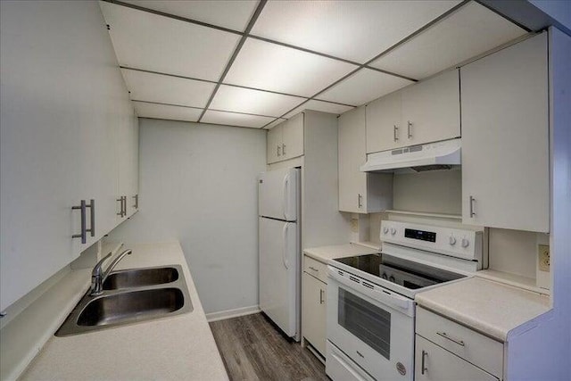 4110 Newport U Unit 4110, Deerfield Beach, FL 33442 - kitchen featuring under cabinet range hood, white appliances, dark wood-type flooring, light countertops, and a paneled ceiling