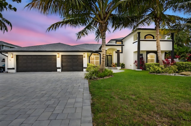 4315 Caryota Dr, Boynton Beach, FL 33436 - view of front of property with a garage, decorative driveway, a yard, and stucco siding