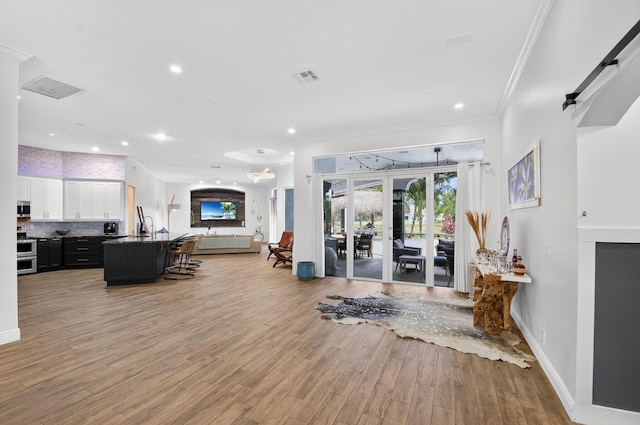 4315 Caryota Dr, Boynton Beach, FL 33436 - workout area featuring light wood-type flooring, crown molding, and recessed lighting