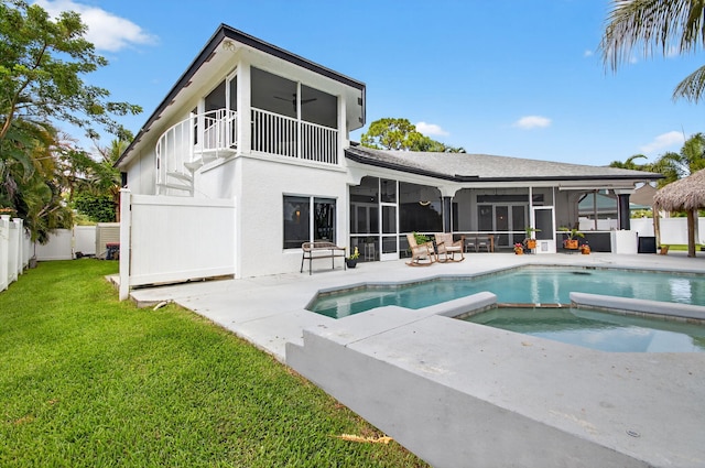 4315 Caryota Dr, Boynton Beach, FL 33436 - back of house with a sunroom, a ceiling fan, a fenced backyard, a patio area, and a pool with connected hot tub