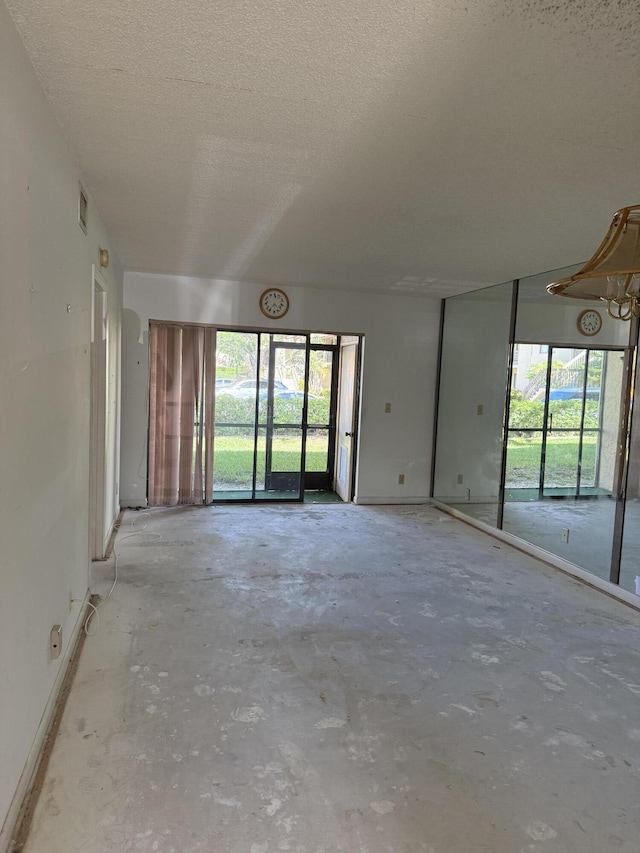 21950 Soundview Ter Unit 107, Boca Raton, FL 33433 - spare room with a textured ceiling and concrete floors